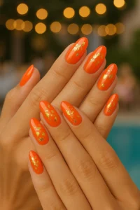 Aperol nails with golden decorations