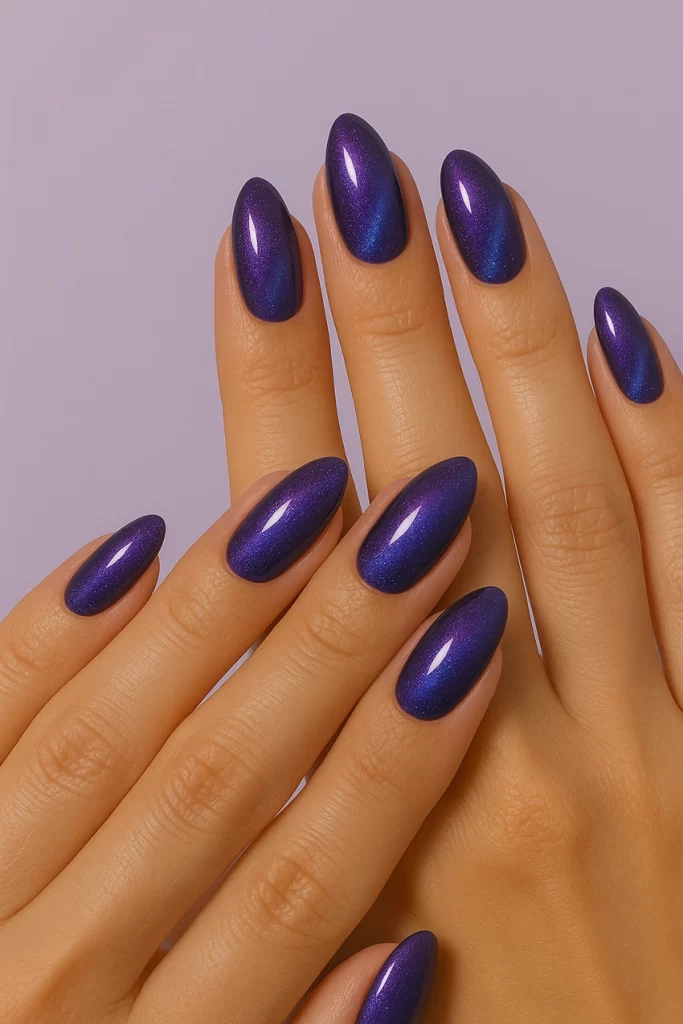 Purple–blue Cat Eye effect on almond-shaped nails