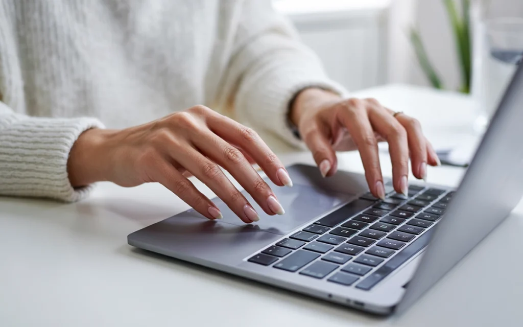 milky white gel polish: a woman showing an elegant almond-shaped clean girl manicure